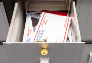 Image of the Large PO Box, Size 4, with small and medium-sized packages and other mail.